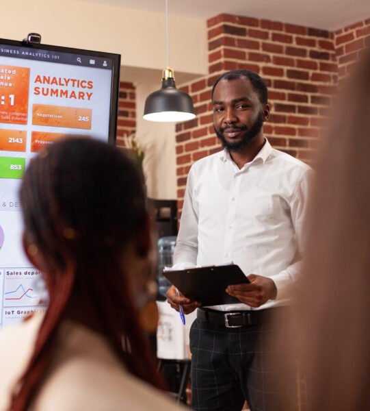 Businesspeople analyzing financial graph working at business presentation Businesspeople analyzing financial graph working at business presentation during startup company office. Diverse entrepreneurs brainstorming ideas for management project discussing partnership